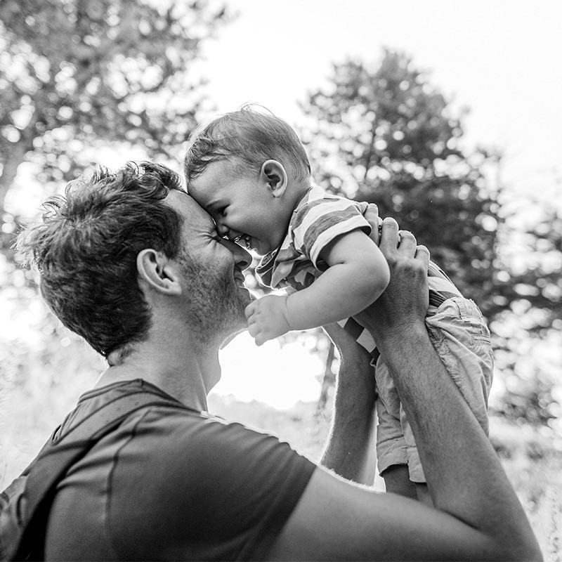 Father holding smiling child